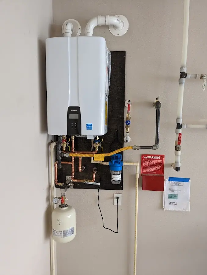 Professional plumber installing copper piping in a Aurora home